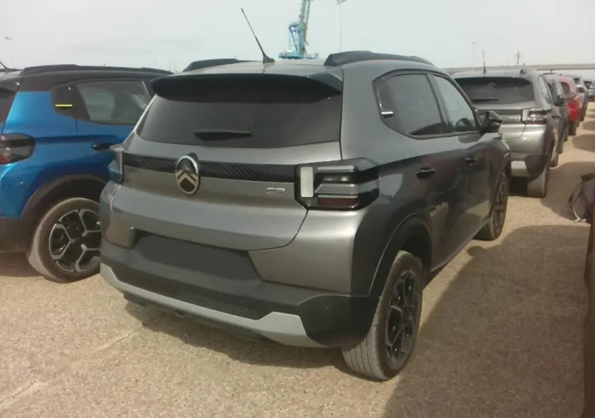 Vue 3/4 arrière droite d'une Citroën C3 Turbo 100 Max gris Mercury avec vitres arrière surteintées et jantes noires.