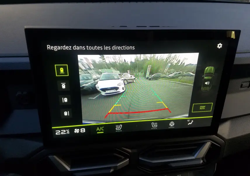 Écran central montrant la caméra de recul du Dacia Duster gris schiste avec lignes de guidage colorées.