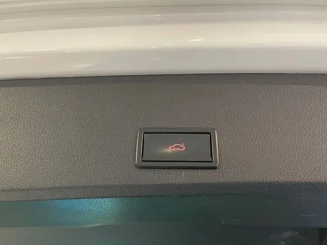 Bouton d'ouverture électrique du coffre sur le hayon intérieur d'un SEAT Ateca blanc Nevada 2017.