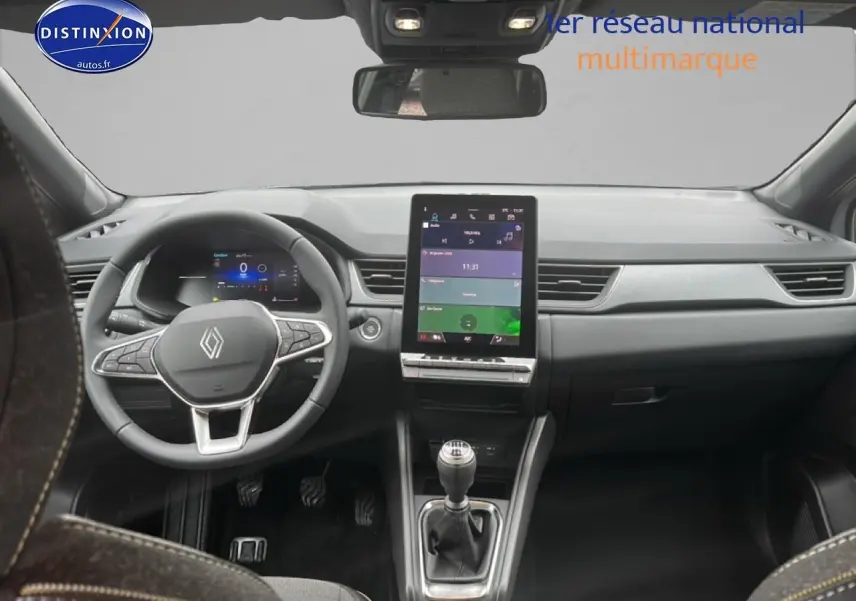 Vue intérieure avant du Renault Captur gris rafale 2025, avec volant multifonction et écran tactile vertical.