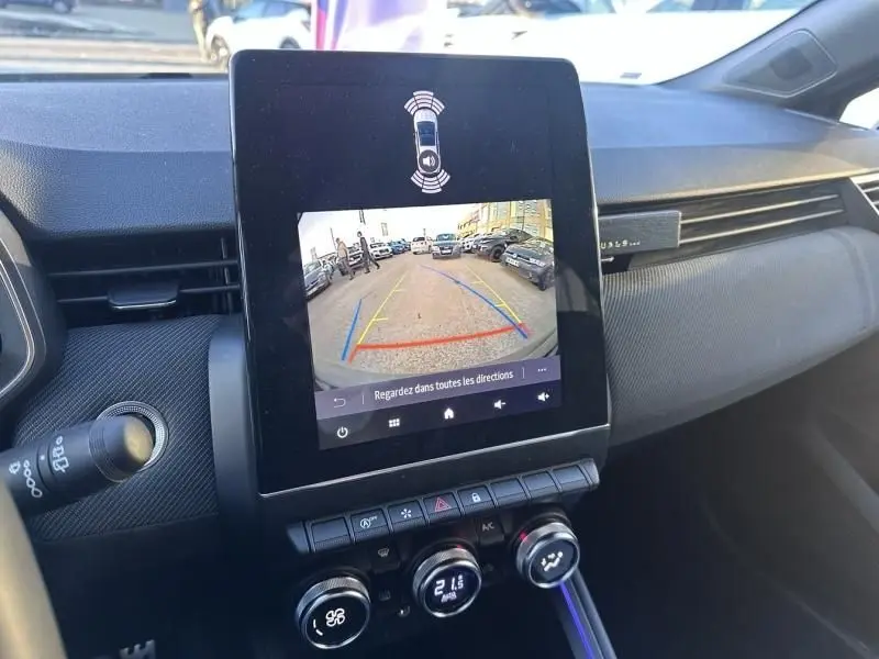 Vue intérieure du tableau de bord de la Renault Clio V gris shiste, avec écran tactile affichant la caméra de recul.