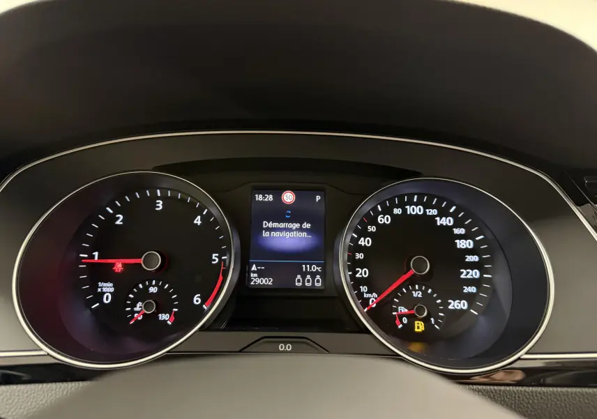 Vue rapprochée du tableau de bord de la Volkswagen Passat SW 2.0 TDI 122 DSG7 Business avec affichage digital et compteurs analogiques.