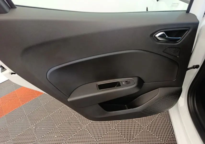 Vue intérieure de la porte côté droit noire de la Renault Clio blanche 2024 avec commande de fenêtre électrique.
