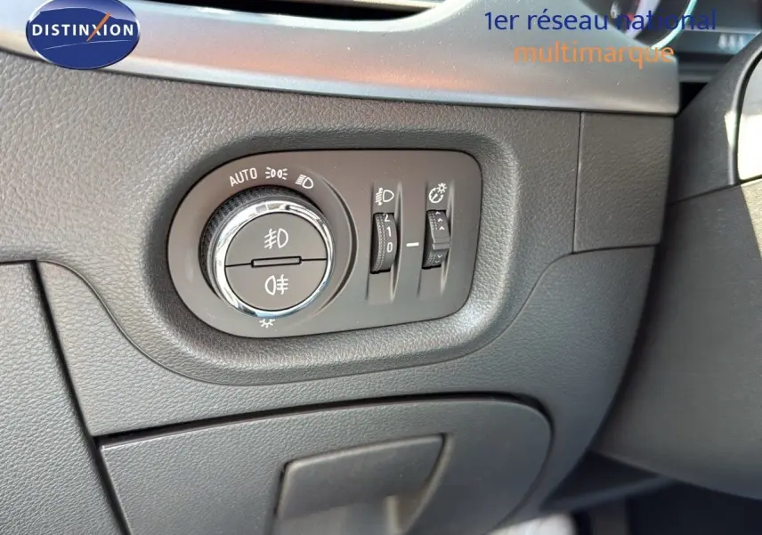 Gros plan sur les commandes d'éclairage à gauche du volant dans l'habitacle gris foncé de l'Opel Astra Sports Tourer 2021.