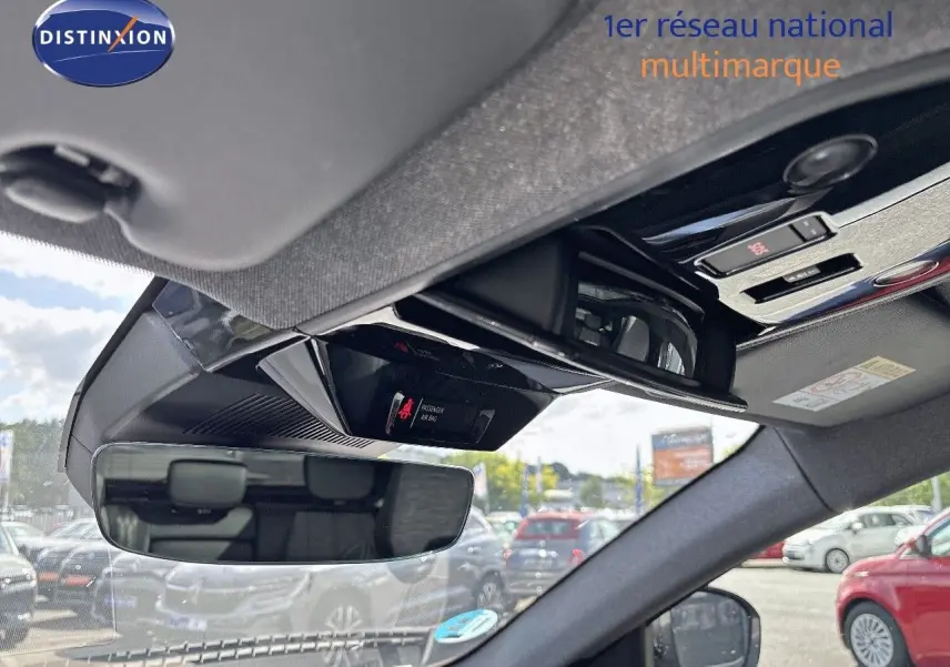 Vue intérieure du rétroviseur central et du plafonnier d'un Renault Austral gris schiste métal, avec commandes et affichage airbag.