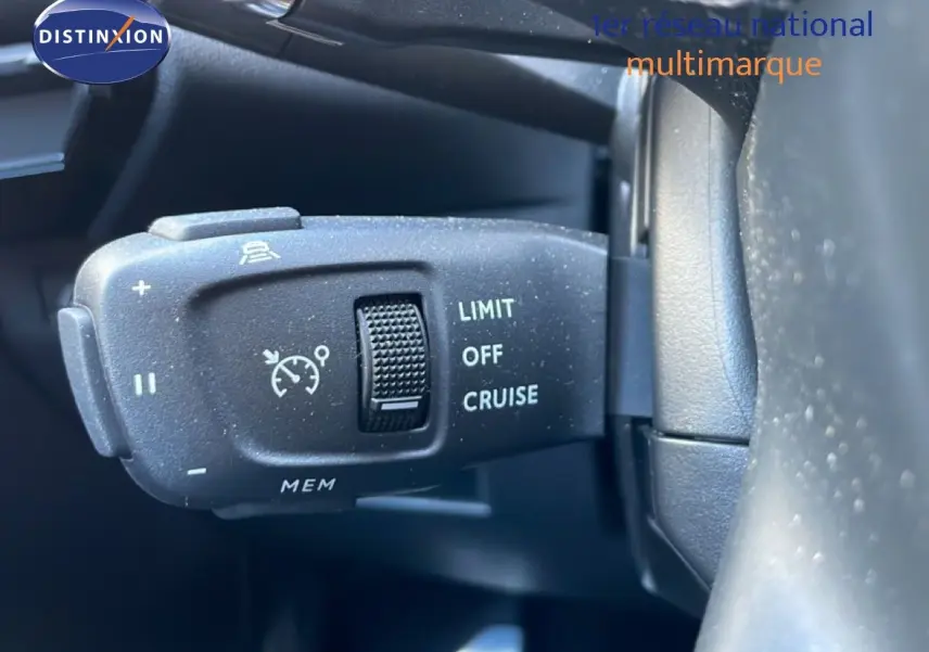 Gros plan sur la commande de régulateur de vitesse à gauche du volant d’un DS7 noir métal 2024.