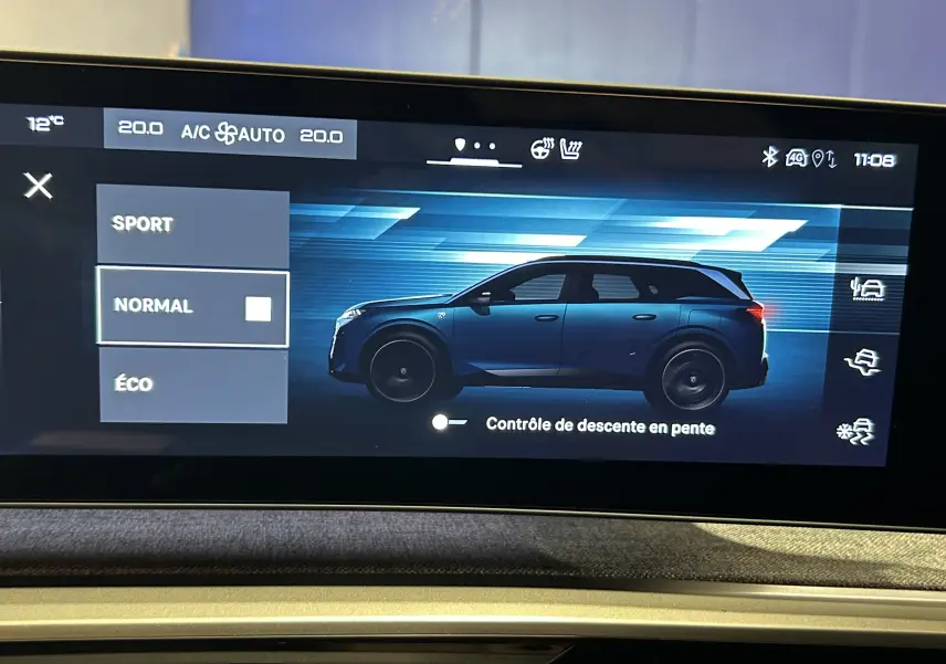 Vue latérale gauche du Peugeot 5008 III Hybrid 145 GT bleu Ingaro affiché sur l'écran multimédia avec mode de conduite sélectionné.