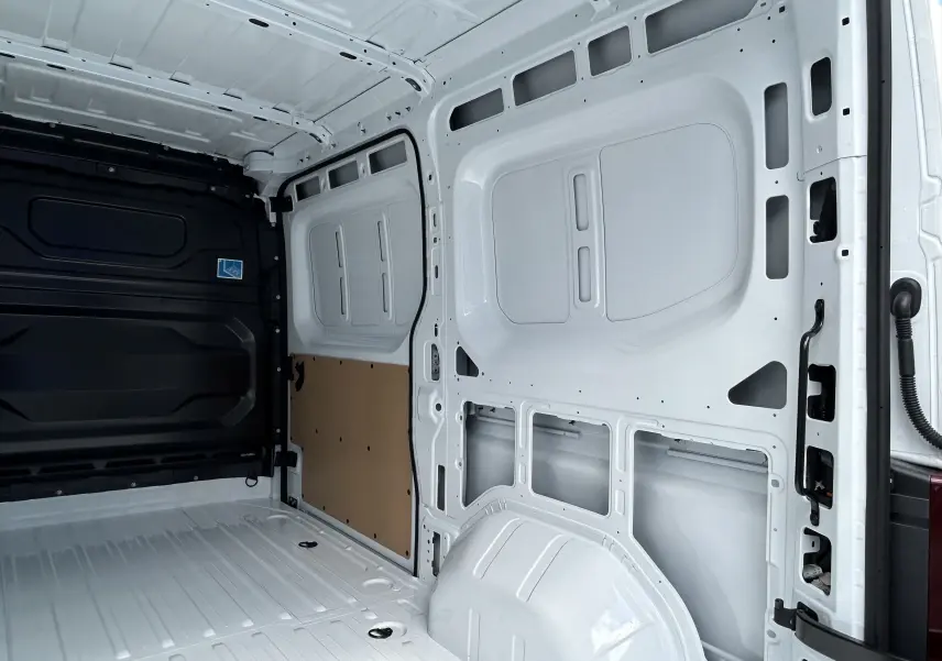 Intérieur arrière du Renault Master blanc, vue côté droit montrant la paroi métallique et le plancher du fourgon.