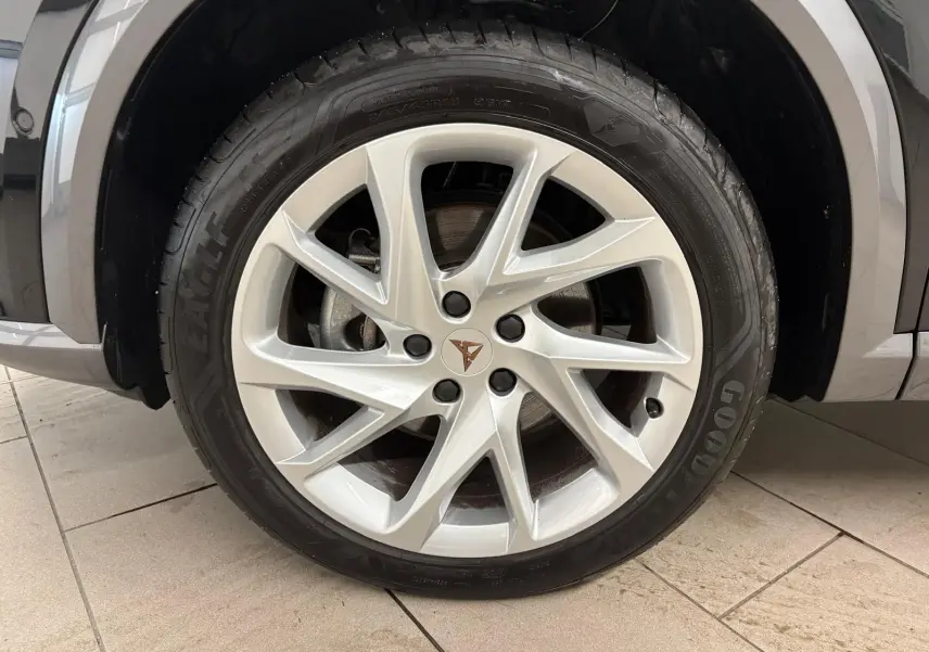 Gros plan sur la roue avant droite du CUPRA Formentor noir minuit, mettant en valeur la jante argentée au design moderne.