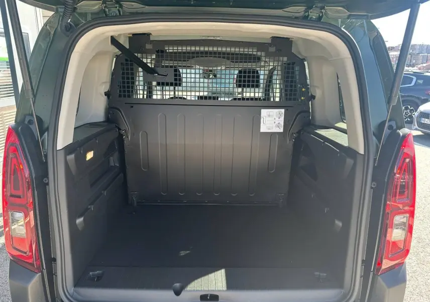 Vue arrière du Citroën Berlingo Sirkka Green avec coffre vide et cloison métallique séparant l'habitacle.