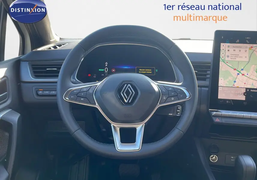 Vue frontale du volant cuir noir du Renault Captur E-Tech Hybrid 2025 avec tableau de bord numérique et écran tactile GPS.