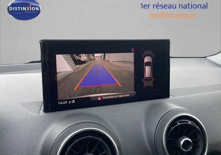Vue intérieure du tableau de bord de l'Audi Q2 35 TFSI 2023, écran affichant la caméra de recul avec guidage de trajectoire.