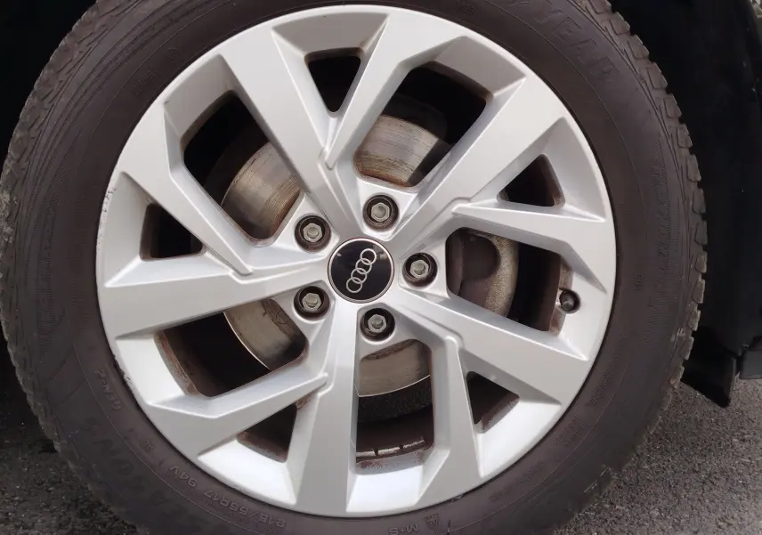 Gros plan sur la jante argentée à 5 branches doubles d'un Audi Q2 noir mito metal de 2023.