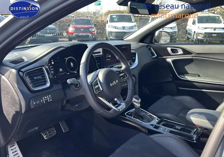 Vue intérieure côté conducteur du Kia Xceed gris 2024, volant cuir multifonction et console centrale avec boîte auto.
