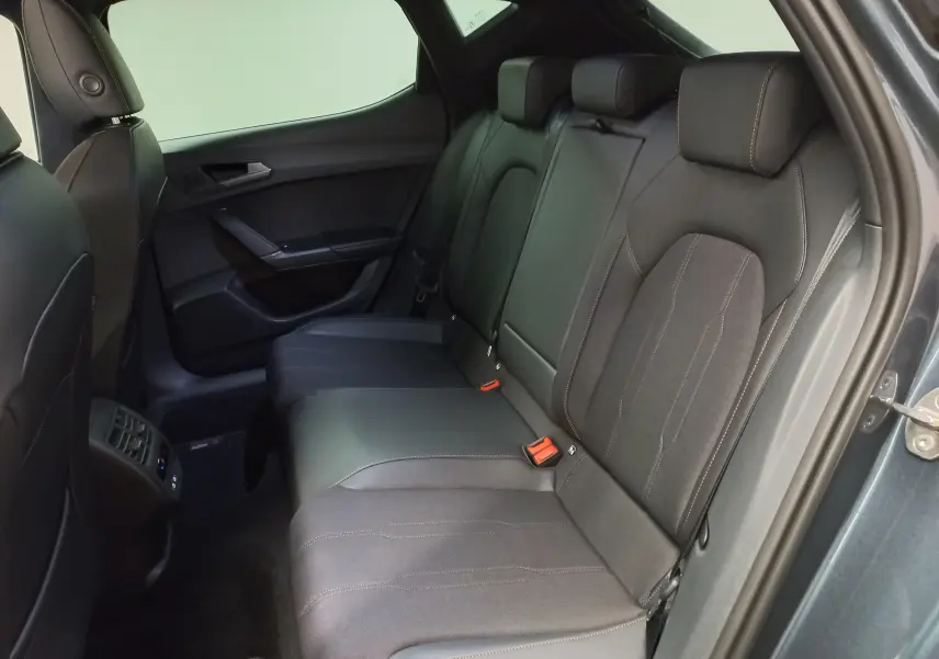 Vue intérieure côté droit des sièges arrière en tissu noir avec surpiqûres cuivrées d'une CUPRA Leon 2025 gris magnétique