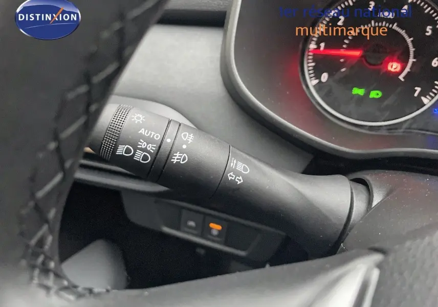 Gros plan sur la manette des phares et clignotants du tableau de bord d'une Dacia Jogger gris schiste métal.