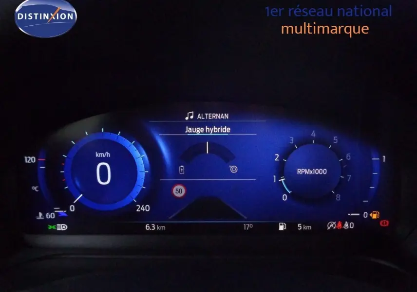 Gros plan sur le tableau de bord numérique bleu du Ford Puma 2022 affichant la jauge hybride et le compteur à zéro.