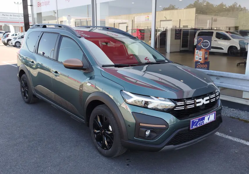 Dacia Jogger 2026 vert cèdre métal en 3/4 avant droit, avec jantes noires et rétroviseurs couleur bronze.