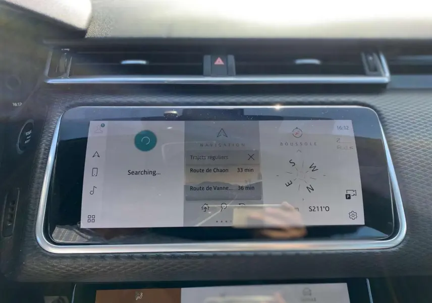 Écran tactile central du Range Rover Velar 2022 affichant la navigation et la boussole dans un intérieur gris.