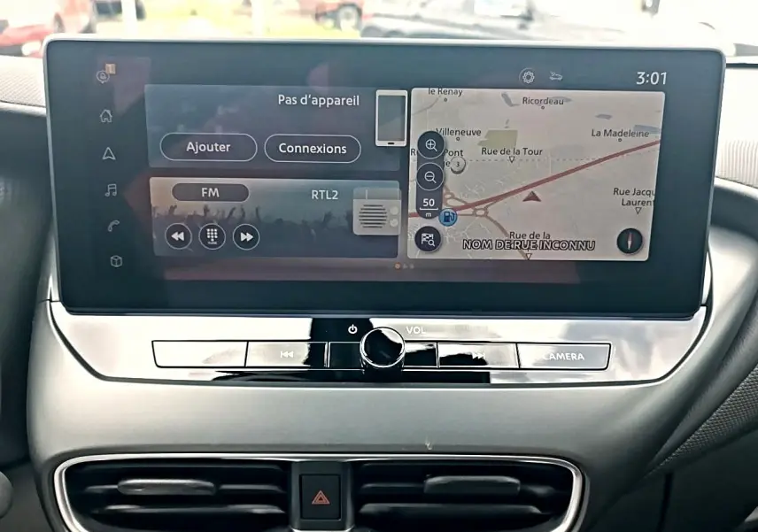 Écran tactile central affichant navigation et radio dans l’habitacle du Nissan Juke gris 2025.