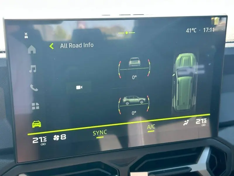 Écran tactile intérieur du Dacia Bigster blanc montrant les aides à la conduite et la climatisation à 21°C.