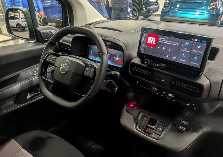 Vue intérieure du poste de conduite du Citroën Berlingo blanc Glacier 2025, avec écran tactile et volant multifonction.