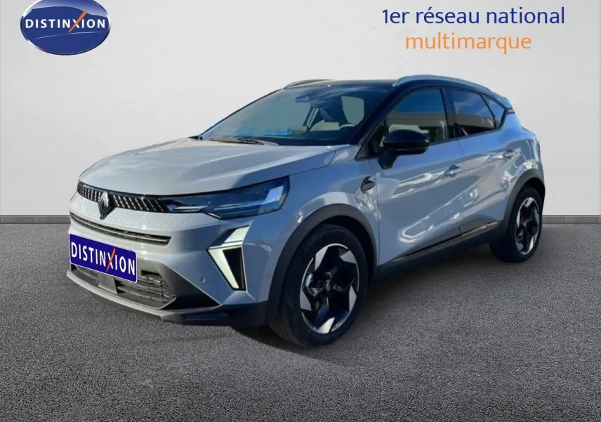 Renault Captur 2025 gris Rafale métal avec toit noir, vue 3/4 avant droit mettant en valeur ses optiques LED et jantes biton.