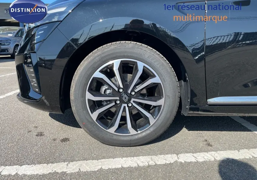 Gros plan sur la roue avant gauche de la Renault Clio TCE 90CH TECHNO noire métal avec jante alliage bicolore.