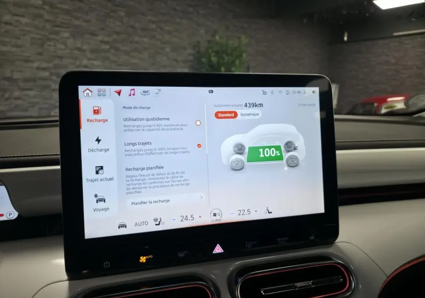 Écran tactile central du tableau de bord d'une Smart #1 blanche affichant l'état de charge à 100%