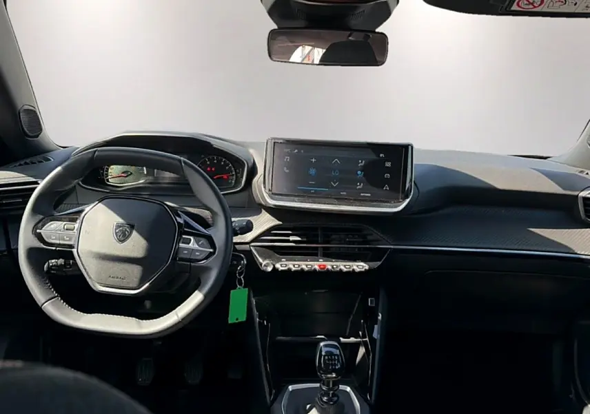 Vue intérieure avant du Peugeot 2008 gris 1.2 100 style, avec volant multifonction et écran tactile central.