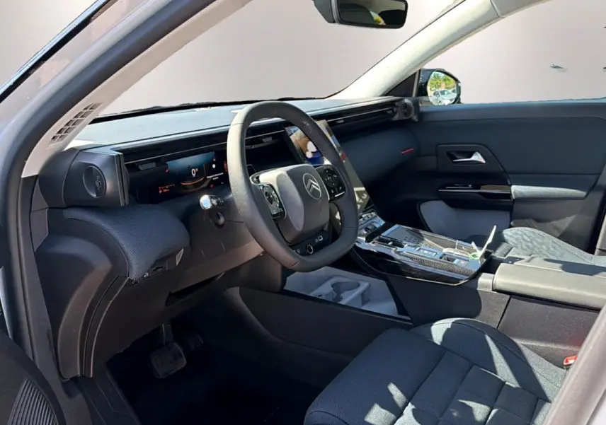 Vue intérieure côté conducteur du Citroën C5 Aircross 2026, tableau de bord numérique et volant multifonction noir.