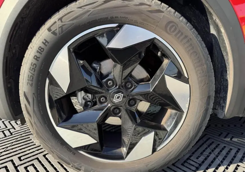 Gros plan sur la roue arrière droite du Renault Captur II rouge flamme avec jante aluminium 18 pouces.