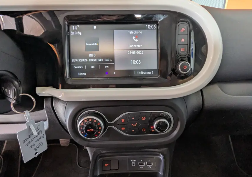 Vue rapprochée du tableau de bord de la Renault Twingo III 1.0 SCE 65 Limited avec écran tactile et commandes de climatisation.