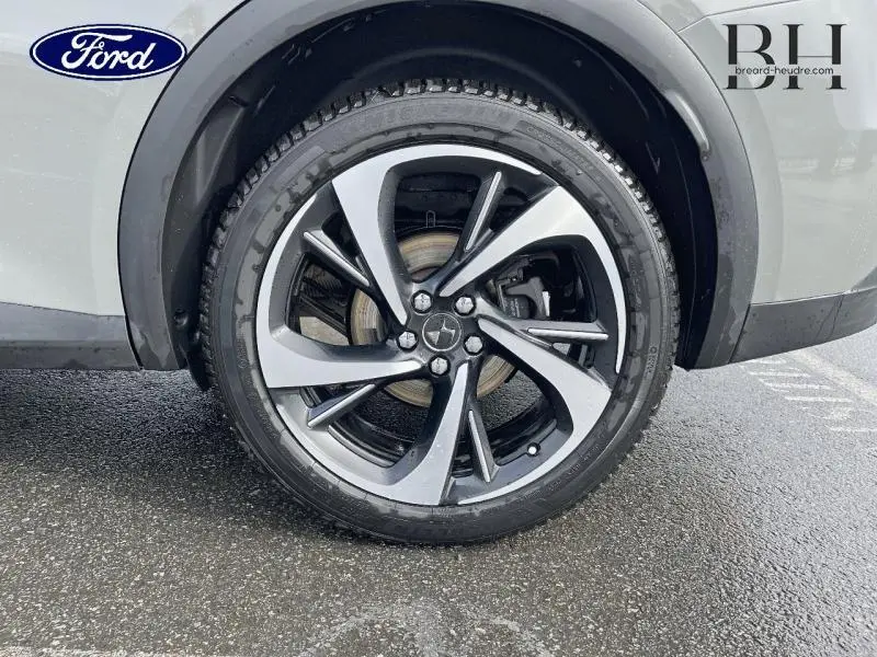 Gros plan sur la roue avant droite d'un DS7 gris laqué avec jante alliage 20 pouces Tokyo au design moderne.