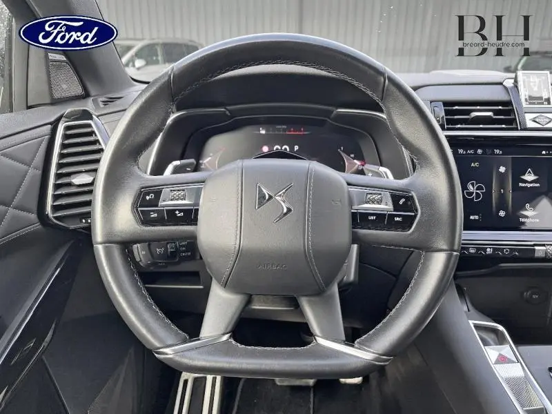 Vue centrée sur le volant cuir noir du DS7 BlueHDi 130ch Opera, avec tableau de bord numérique et écran tactile visible à droite.