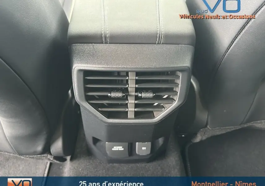 Détail de la console arrière avec bouches d’aération et prises USB du Volkswagen Amarok Aventura bleu, vue intérieure centrée.