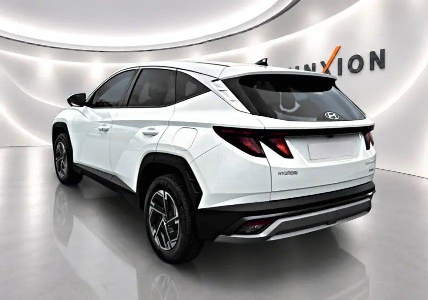 Vue 3/4 arrière droite du Hyundai Tucson blanc 2026 avec jantes alliage et feux arrière LED distinctifs.