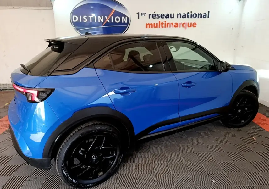 Opel Mokka 2024 bleu vue de profil droit, toit noir, jantes noires et feux arrière LED visibles.