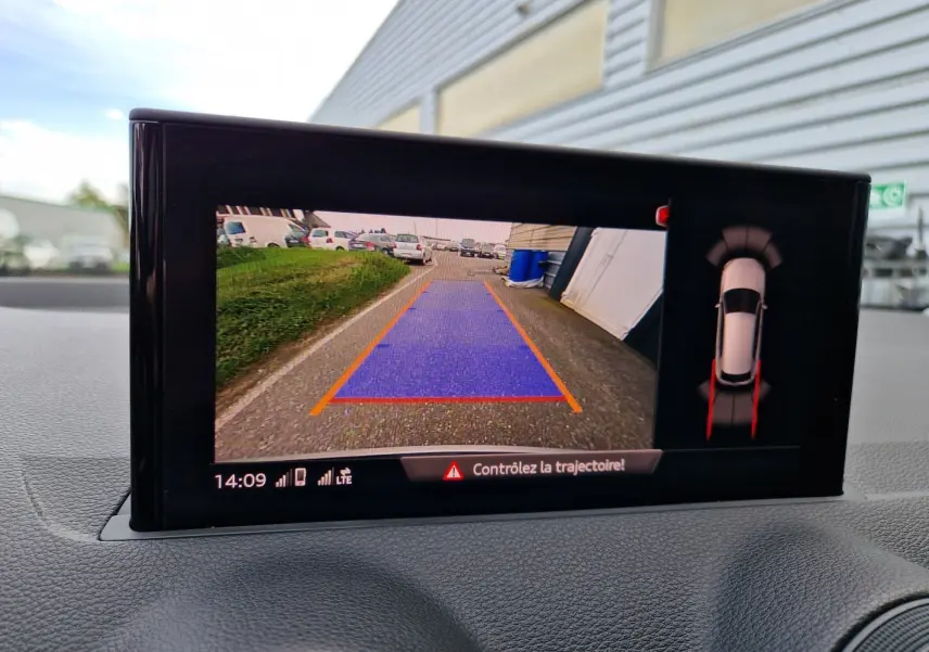 Écran multimédia affichant la caméra de recul avec trajectoire en bleu et vue 360° du Q2 noir mito metal en stationnement.