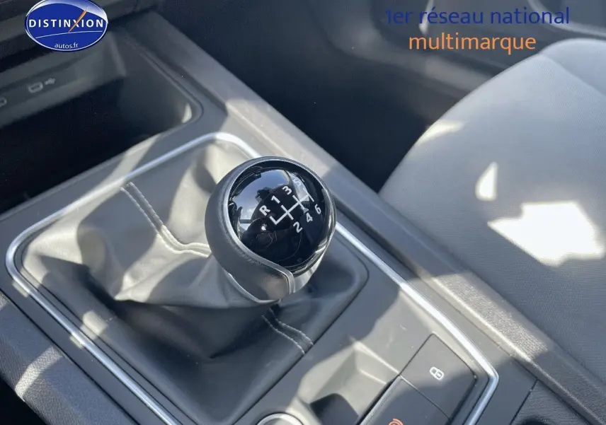 Gros plan sur le levier de vitesses manuel noir dans l'habitacle d'une SEAT LEON IV gris magnétique 2024.