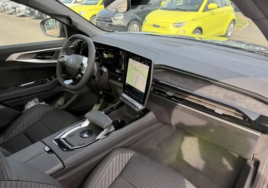 Vue intérieure côté conducteur du Renault Austral 2026, avec tableau de bord noir et écran tactile vertical.