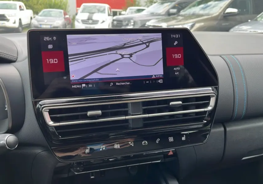 Tableau de bord du Citroën C5 Aircross Hybrid 2025 avec écran tactile affichant la navigation et commandes climatisation.