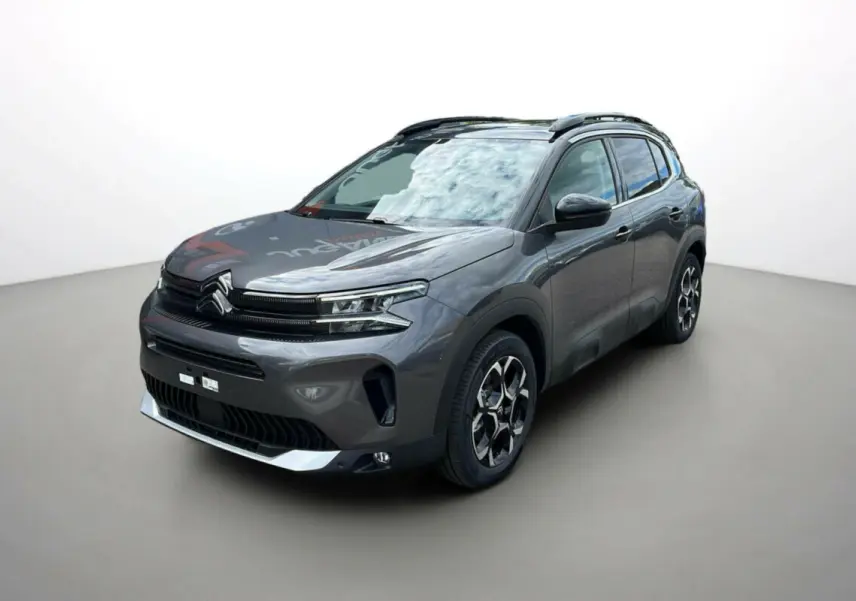 Citroën C5 Aircross Hybrid 2025 gris platinium avec toit noir, vue 3/4 avant mettant en valeur ses jantes distinctives.
