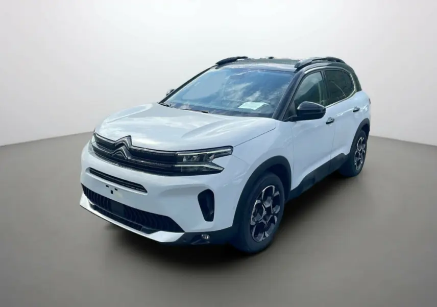 Citroën C5 Aircross Hybrid 2025 blanc okénite avec toit noir, vue 3/4 avant droit sur fond neutre.