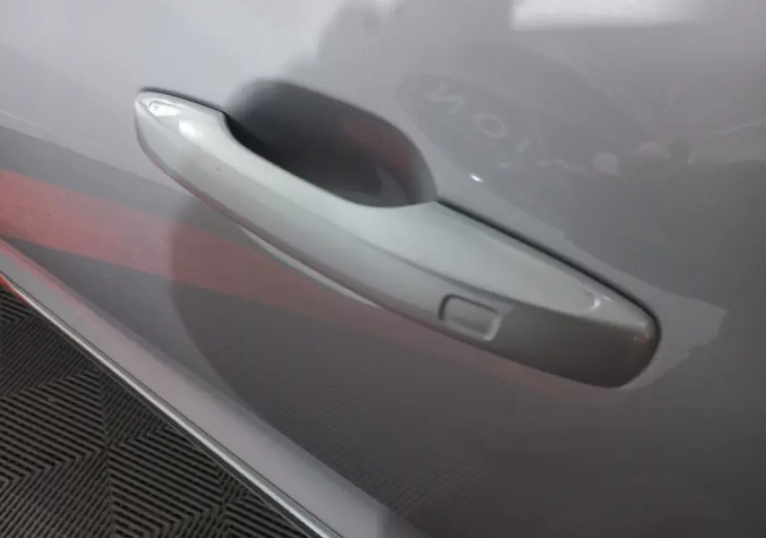 Poignée de porte gris clair côté droit du Volvo XC60 B4 197 Geartronic 8 Inscription 2022 avec bouton d'ouverture intégrée.