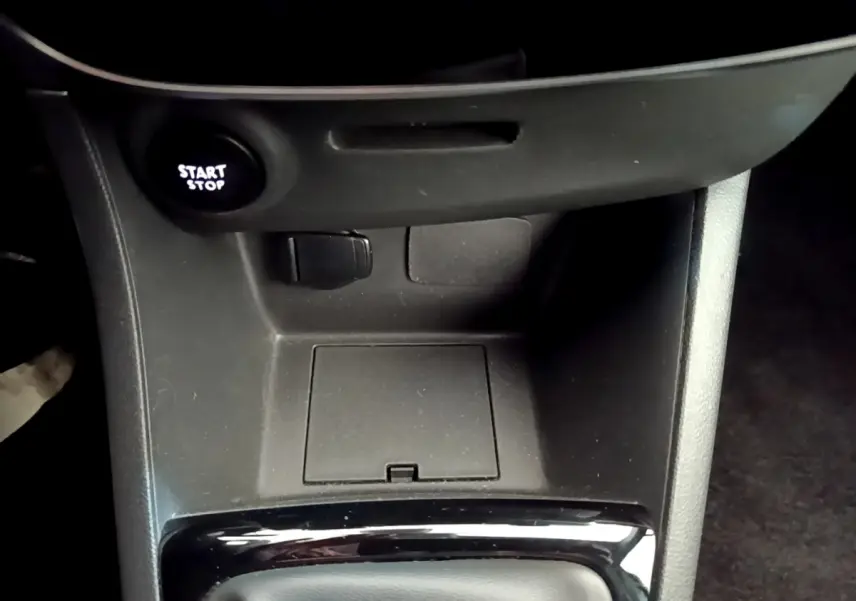 Gros plan sur la console centrale noire de la Renault Clio Business TCe 90 avec bouton Start/Stop éclairé.