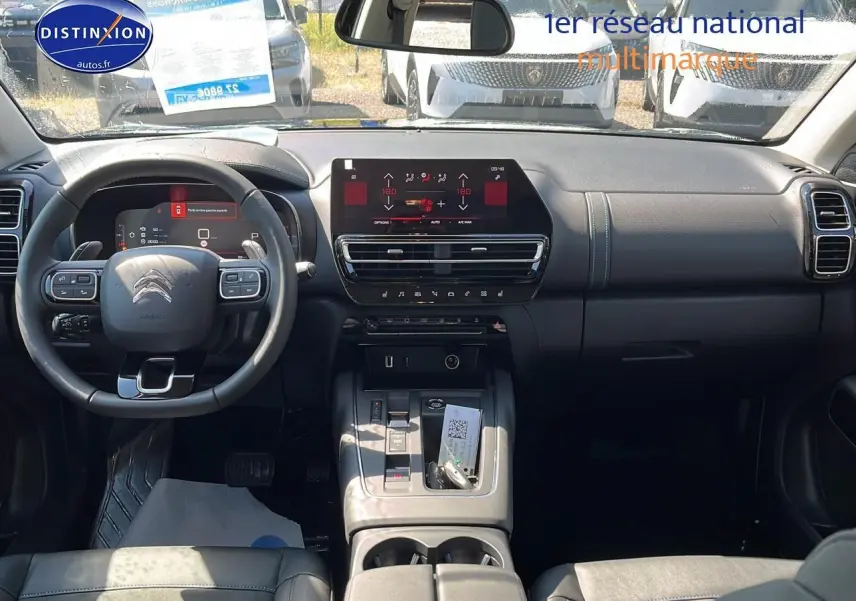 Intérieur du Citroën C5 Aircross 2025 en vue avant, tableau de bord noir avec écran tactile et volant multifonction.