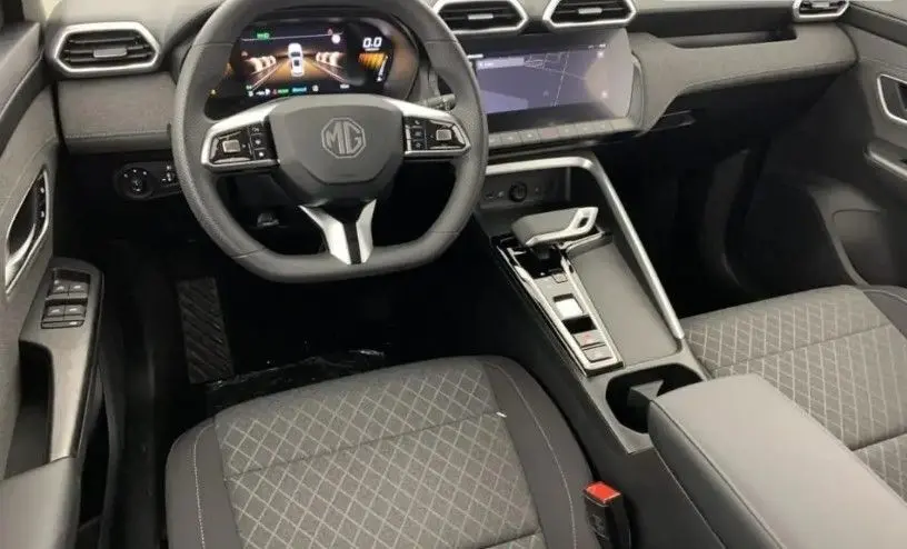 Vue intérieure avant du MG ZS 2025 en tissu noir, avec volant multifonction et écran tactile 10,25 pouces.