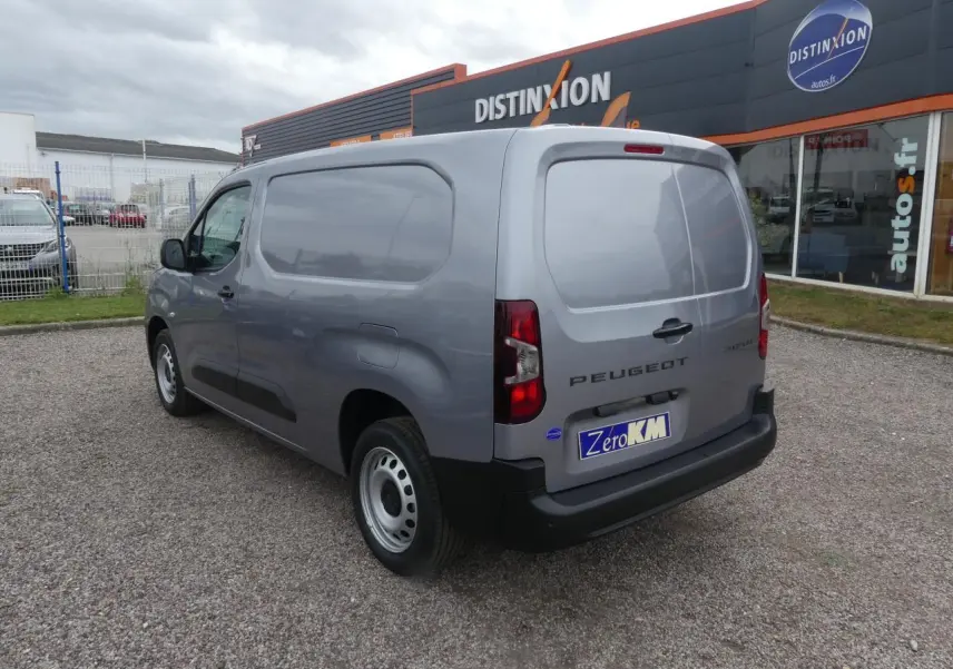 Vue 3/4 arrière droite d'un Peugeot Partner XL gris métallisé avec portes arrière battantes et jantes tôles grises.