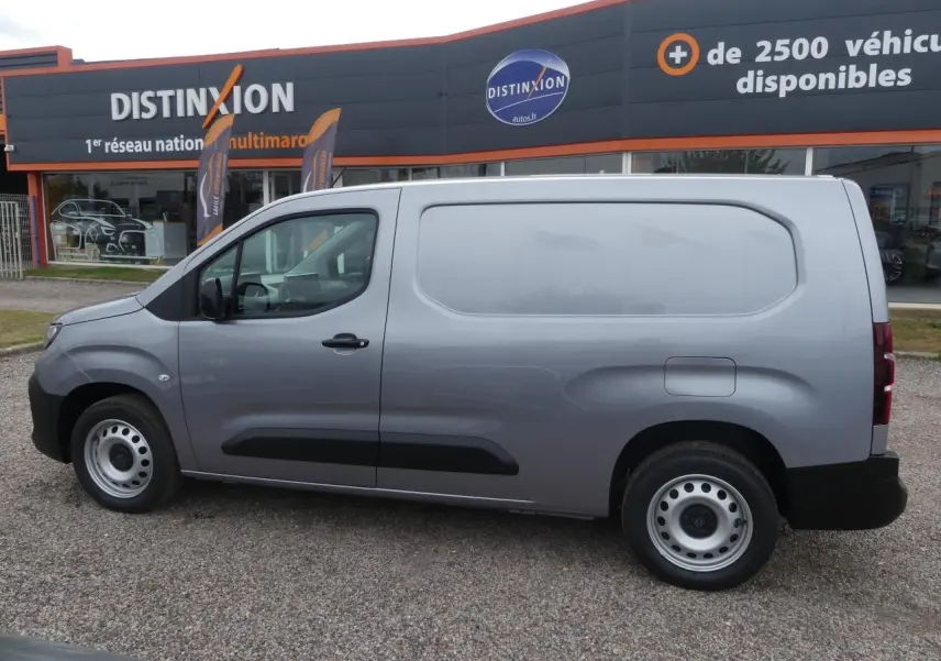 Vue latérale droite d'un Peugeot Partner gris métallisé 2025, utilitaire avec portes tôlées et jantes acier simples.